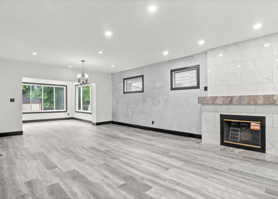Finished room with recessed lighting and a wall fireplace